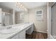 Bathroom featuring wood-look flooring, double sinks, and a glass shower at 9522 Castle Ridge Cir, Highlands Ranch, CO 80129