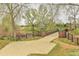 A bridge leads to community park amenities, including a gazebo, playground, and walking paths surrounded by lush green space at 9522 Castle Ridge Cir, Highlands Ranch, CO 80129