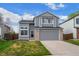 Charming gray two-story home with a well-maintained lawn and attached two-car garage at 9522 Castle Ridge Cir, Highlands Ranch, CO 80129