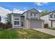 Charming gray two-story home with a well-maintained lawn and attached two-car garage at 9522 Castle Ridge Cir, Highlands Ranch, CO 80129