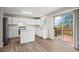 Bright kitchen with white cabinets, an island, and a sliding door to the deck at 9522 Castle Ridge Cir, Highlands Ranch, CO 80129