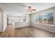 Bright open concept living room with wood floors connects to the kitchen with a breakfast bar at 9522 Castle Ridge Cir, Highlands Ranch, CO 80129