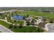 Aerial of green park featuring a playground, pond, and walking paths near lovely homes at 9522 Castle Ridge Cir, Highlands Ranch, CO 80129