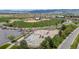 Aerial shot of a modern skate park next to baseball field, featuring smooth concrete and mountain views at 9522 Castle Ridge Cir, Highlands Ranch, CO 80129