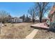 Large backyard with a tool shed, mature trees and a wood deck at 7232 Kalamath St, Denver, CO 80221