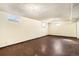 Unfinished basement with dark floors, painted walls and windows at 7232 Kalamath St, Denver, CO 80221