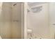 Clean bathroom with a shower and toilet in a white tiled room with new fixtures at 7232 Kalamath St, Denver, CO 80221