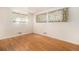 This bedroom features light walls, hardwood floors and vintage floral print curtains at 7232 Kalamath St, Denver, CO 80221