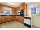 Functional kitchen with warm cabinetry and efficient appliances at 7232 Kalamath St, Denver, CO 80221