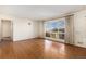 Bright living room with polished hardwood floors and large window at 7232 Kalamath St, Denver, CO 80221