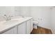Elegant bathroom featuring double sinks, white cabinetry, and modern fixtures at 24737 E 40Th Ave, Aurora, CO 80019