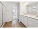Modern bathroom featuring double sinks, walk-in shower, and wood-style flooring at 24737 E 40Th Ave, Aurora, CO 80019