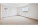 Bright bedroom with neutral carpet and two windows providing natural light at 24737 E 40Th Ave, Aurora, CO 80019