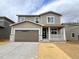 Two-story home featuring a front porch, a two-car garage, and neutral-toned siding at 24737 E 40Th Ave, Aurora, CO 80019