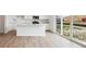 Bright kitchen with white cabinets, stainless appliances, and sliding glass doors to the backyard at 24737 E 40Th Ave, Aurora, CO 80019