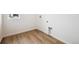 Functional laundry room with wood-style flooring and washer/dryer hookups at 24737 E 40Th Ave, Aurora, CO 80019