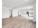 Bright, open-concept living space featuring light wood floors and a modern white kitchen at 24737 E 40Th Ave, Aurora, CO 80019