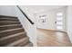 Welcoming entryway showcasing stairs with dark trim and wood-look flooring, providing a modern and inviting space at 24737 E 40Th Ave, Aurora, CO 80019