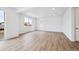 Bright living room features wood-look flooring, and large windows providing natural light and an open feel at 24737 E 40Th Ave, Aurora, CO 80019