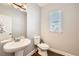 Powder room with pedestal sink and updated toilet at 3980 Trailstone Cir, Castle Rock, CO 80108