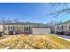 View of the backyard with brick exterior, privacy fence, and a manicured lawn at 1209 Locust St, Denver, CO 80220