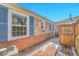 Brick patio with privacy fence and blue shutters on exterior of home at 1209 Locust St, Denver, CO 80220