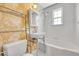 Charming bathroom with floral wallpaper, hexagon tile floor, and combined tub and shower at 1209 Locust St, Denver, CO 80220