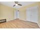 Bright bedroom with hardwood floors, ceiling fan, closet, and an adjacent bathroom at 1209 Locust St, Denver, CO 80220