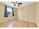 Well-lit bedroom featuring hardwood floors and a bright window with blue curtains at 1209 Locust St, Denver, CO 80220