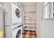 Functional laundry room with modern washer and dryer and shelving at 1209 Locust St, Denver, CO 80220