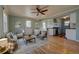 Open-concept living room with hardwood floors, flowing into the kitchen and natural light at 1209 Locust St, Denver, CO 80220