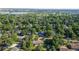 Gorgeous aerial view of the community with mature trees, nearby lake, and well-manicured streets at 13990 Berry Rd, Golden, CO 80401