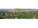 Panoramic aerial view of a tree-filled neighborhood with homes nestled among the lush greenery at 13990 Berry Rd, Golden, CO 80401