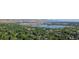 Stunning aerial view of a serene community surrounded by lush trees and overlooking a beautiful lake at 13990 Berry Rd, Golden, CO 80401
