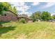 This yard features a spacious lawn, mature trees, shed and a charming gazebo style patio at 13990 Berry Rd, Golden, CO 80401