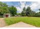 A large backyard featuring a shed, garden boxes and mature trees, perfect for outdoor activities and gardening at 13990 Berry Rd, Golden, CO 80401