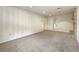 Large carpeted basement area with utility hookups and separate doorways at 13990 Berry Rd, Golden, CO 80401
