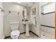 Bathroom featuring vintage fixtures, a decorative mirror, and tiled walk in shower at 13990 Berry Rd, Golden, CO 80401