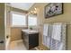 Bathroom featuring double sinks, tub and shower combo and plenty of natural light at 13990 Berry Rd, Golden, CO 80401