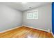 This bedroom features hardwood floors, a large window and neutral decor at 13990 Berry Rd, Golden, CO 80401
