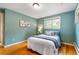 Cozy bedroom features warm wood floors and a calming color palette at 13990 Berry Rd, Golden, CO 80401