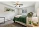 Carpeted bedroom with ceiling fan and two windows offering natural light at 13990 Berry Rd, Golden, CO 80401