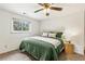 Inviting carpeted bedroom with a ceiling fan and natural light at 13990 Berry Rd, Golden, CO 80401