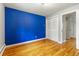 Bright bedroom features hardwood floors, closet and door leading to hallway at 13990 Berry Rd, Golden, CO 80401
