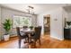 Dining area features hardwood floors, a round table set for four, and an adjacent kitchen at 13990 Berry Rd, Golden, CO 80401