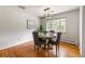 Charming dining room with hardwood floors, a round table set for four, and a stylish light fixture at 13990 Berry Rd, Golden, CO 80401