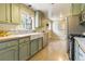 Charming kitchen features updated cabinets, stainless steel appliances and a farmhouse sink at 13990 Berry Rd, Golden, CO 80401