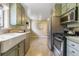 Kitchen showcases stainless steel appliances and an expansive view of the dining area at 13990 Berry Rd, Golden, CO 80401