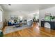 Bright living room with hardwood floors, stylish furniture, and an open dining area at 13990 Berry Rd, Golden, CO 80401