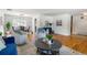Inviting living room featuring hardwood floors, neutral decor, and seamless access to the dining area at 13990 Berry Rd, Golden, CO 80401